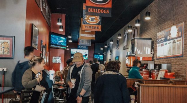 Group of people standing inside restaurant
