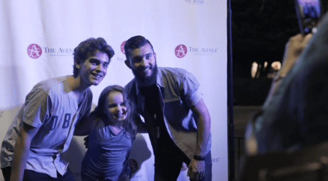 Two men posing for photo with little girl
