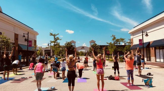 People doing yoga outside in the sun