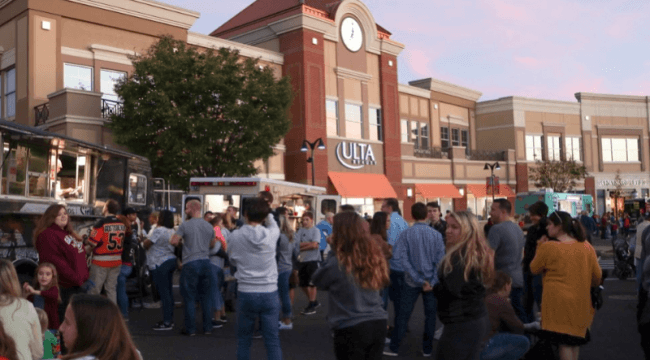 Groups of people in front of various store fronts